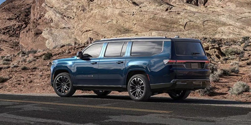 blue Grand Wagoneer on road