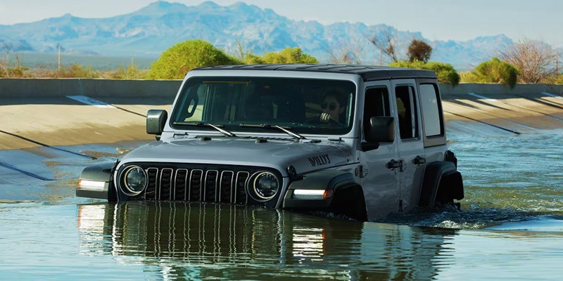 2026 Jeep Wrangler driving through deep water.