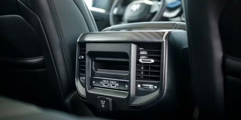 2026 RAM 1500 interior close-up, highlighting the sleek climate control system and premium finishes.