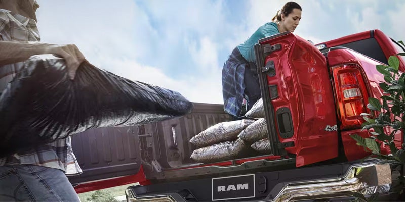 2026 RAM 1500 bed loaded with bags, demonstrating its hauling capability.